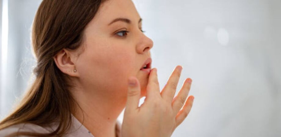 Mulher conferindo lábios por conta de boca seca da xerostomia